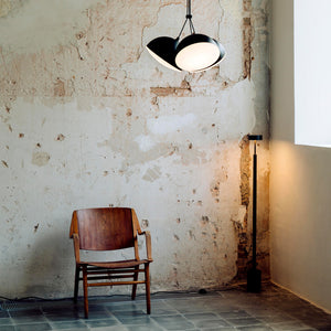 adjustable black 3 head pendant light in an industrial living room