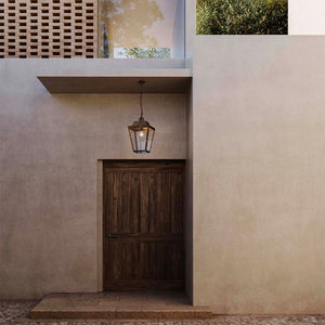 Pre Aged Brass Exterior Lantern Pendant transparent glass at the front entrance of a house